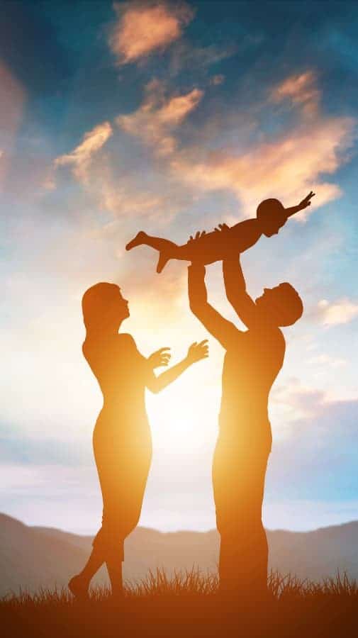 Couple holding child in the air 2