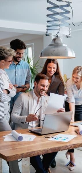 People working together by a laptop